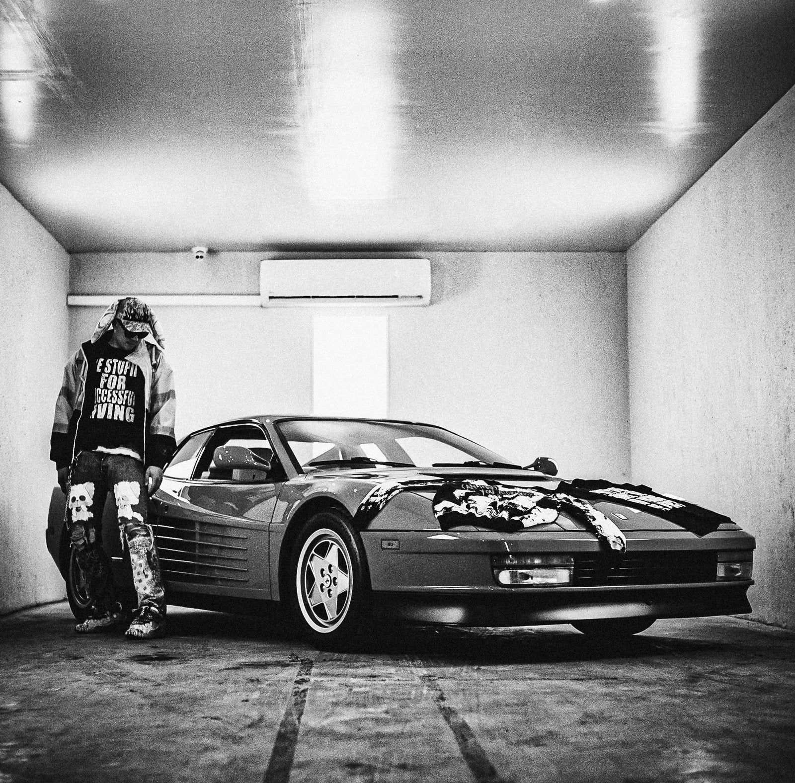 Campaign image, black and white, Testarossa in a parking structure